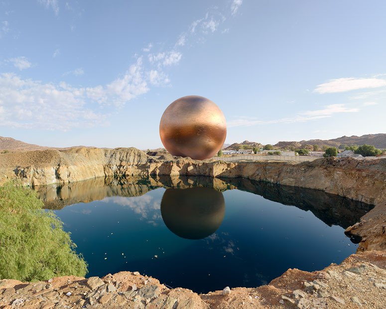 A rendering of a copper sphere behind a lake in a closed mine